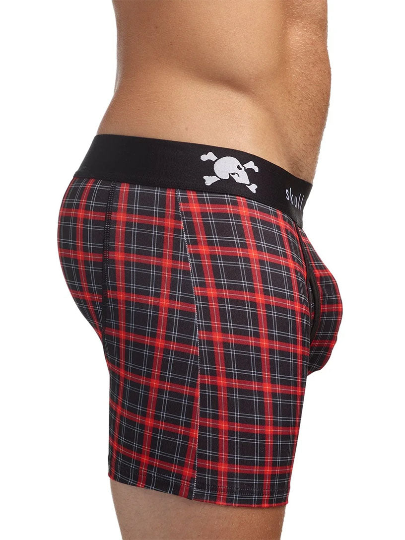 Red and black plaid boxer briefs with skull logo on waistband on a white background